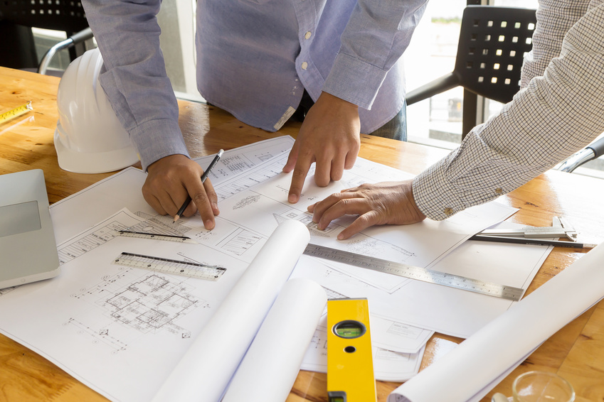 two people reviewing architectural plans
